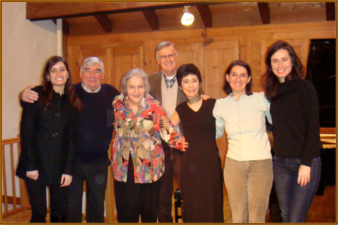 Group photograph of Yuuko Suzuki with six others in the wood-panelled hall at Centre Phénix after the recital