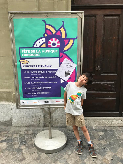 Street poster listing the Fête de la Musique Fribourg programme at Centre le Phénix, with Yuuko Suzuki and Ricardo at 17h00